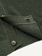 Close-up of clean ribbed hem on olive contrast trim polo knit cardigan