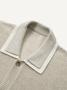 Close-up of double polo collar with white contrast under-layer on oatmeal rib-knit sweater cardigan