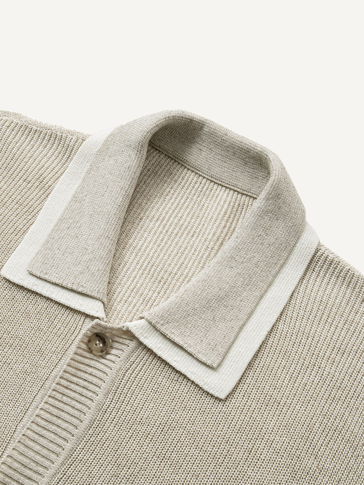 Close-up of double polo collar with white contrast under-layer on oatmeal rib-knit sweater cardigan
