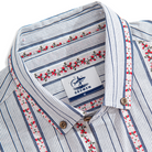 Close-up of floral embroidery and textured stripes on cotton shirt
