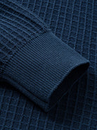 Close-up of shape-retention ribbed knit sleeve cuffs on polo cardigan