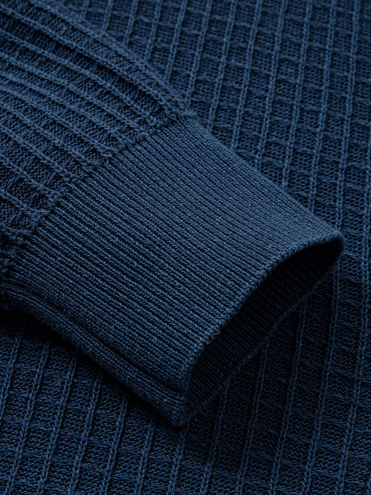 Close-up of shape-retention ribbed knit sleeve cuffs on polo cardigan