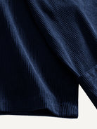 Close-up of the wide sleeve cuff and pleated finish