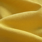 Close-up of yellow viscose ice silk knit fabric with diamond jacquard stripe pattern – OROMEN