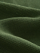 Close-up texture of vertical contrast stripe knit fabric on OROMEN Marcel Striped Knit Polo