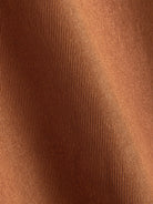 Close-up texture of warm caramel cotton fabric on OROMEN Rust Hooded Utility Shirt