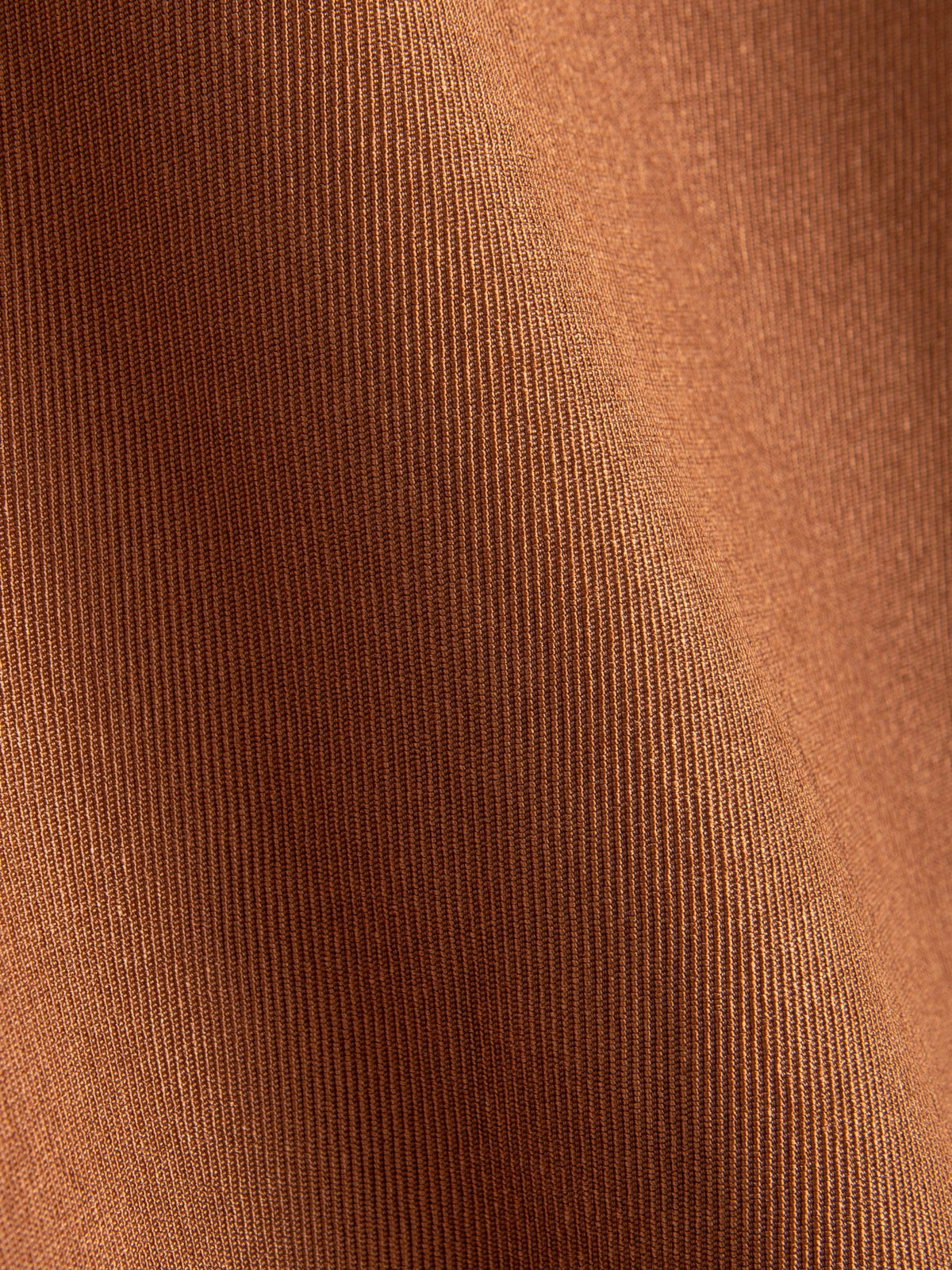 Close-up texture of warm caramel cotton fabric on OROMEN Rust Hooded Utility Shirt