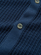 Close-up view of tonal front buttons on OROMEN ribbed polo sweater cardigan