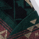 Close-up of OROMEN KIMONO018 jacquard pattern detail, intricate woven motif, navy and contrast thread interplay, artisan textile