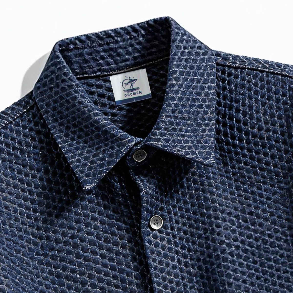 Close-up of OROMEN OROAW042 shirt collar and button placket, navy checkered jacquard weave, clean collar construction, handmade finish