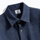 Close-up of OROMEN OROAW042 shirt collar and button placket, navy checkered jacquard weave, clean collar construction, handmade finish