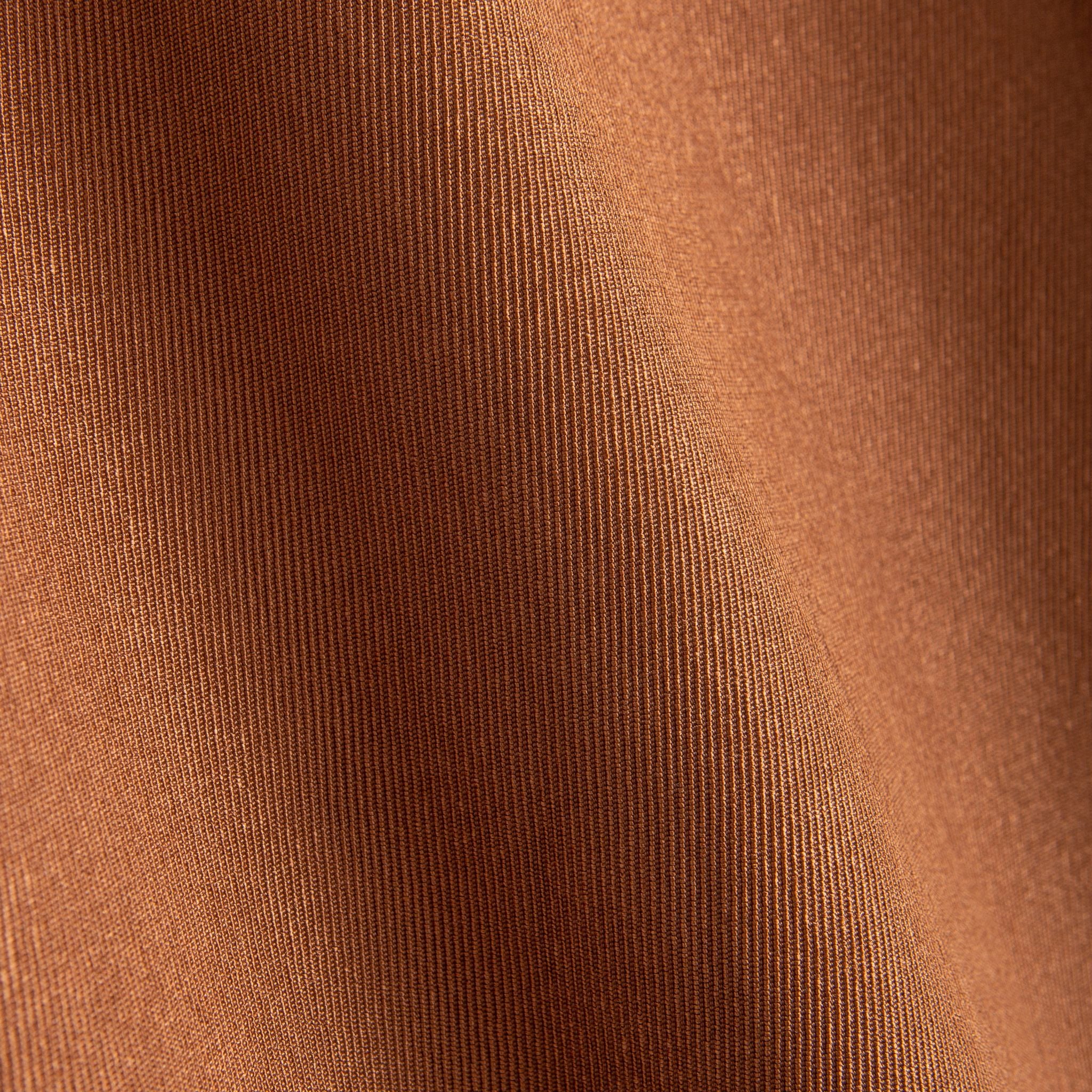 Close-up of rust brown 100% polyester fabric texture on OROMEN hooded short-sleeve shirt