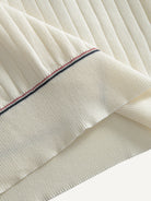 Contrast stitch bottom hem detail on OROMEN Cream Court Knit Polo
