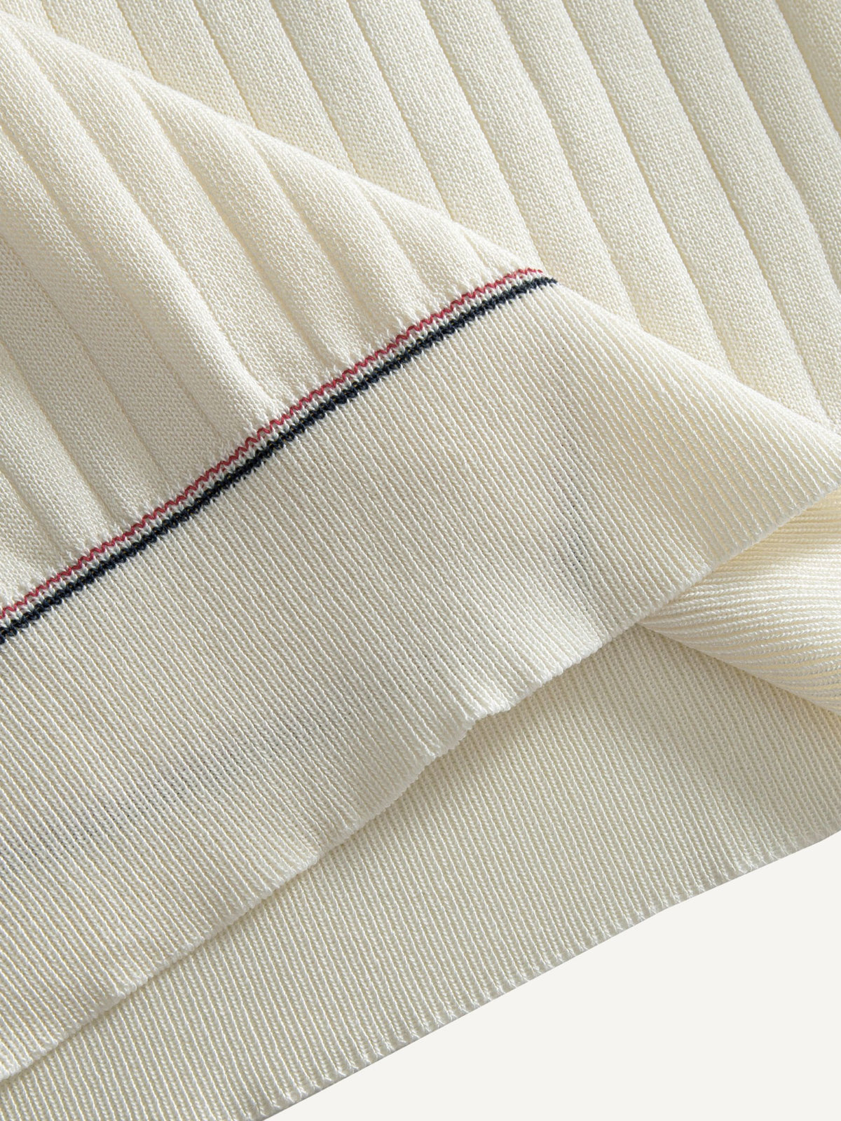 Contrast stitch bottom hem detail on OROMEN Cream Court Knit Polo