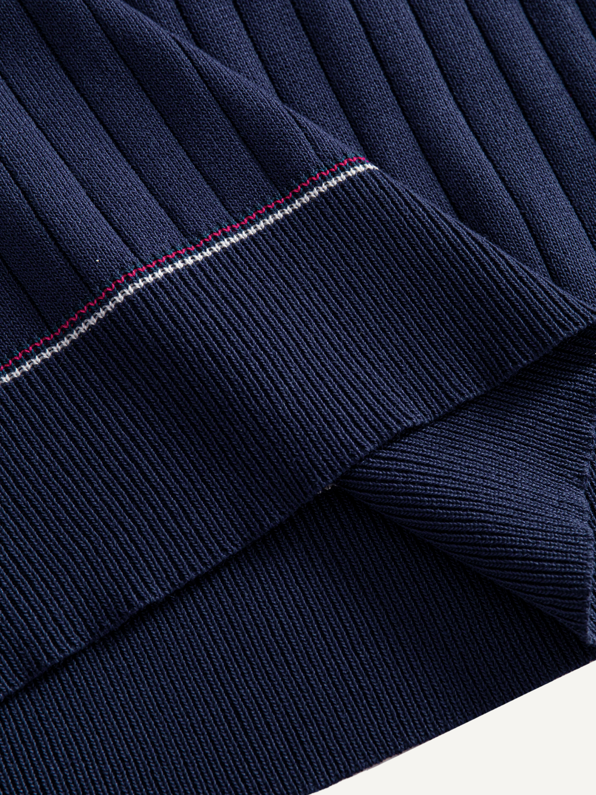Contrast tipped hem detail on OROMEN Contrast-Tipped Ribbed Knit Polo