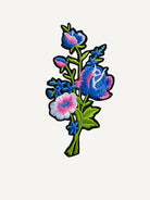 Delicately stitched blooming wildflower embroidery artwork on OROMEN T-shirt
