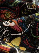 Detailed view of 100% cotton fabric with vibrant Day of the Dead mariachi skull print