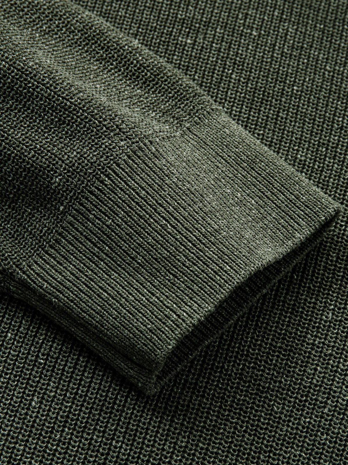 Detailed view of long sleeve ribbed cuffs on heathered olive knit cardigan