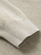 Detailed view of long sleeve ribbed cuffs on oatmeal sweater cardigan