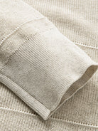 Detailed view of long sleeve ribbed cuffs on oatmeal textured polo knit cardigan