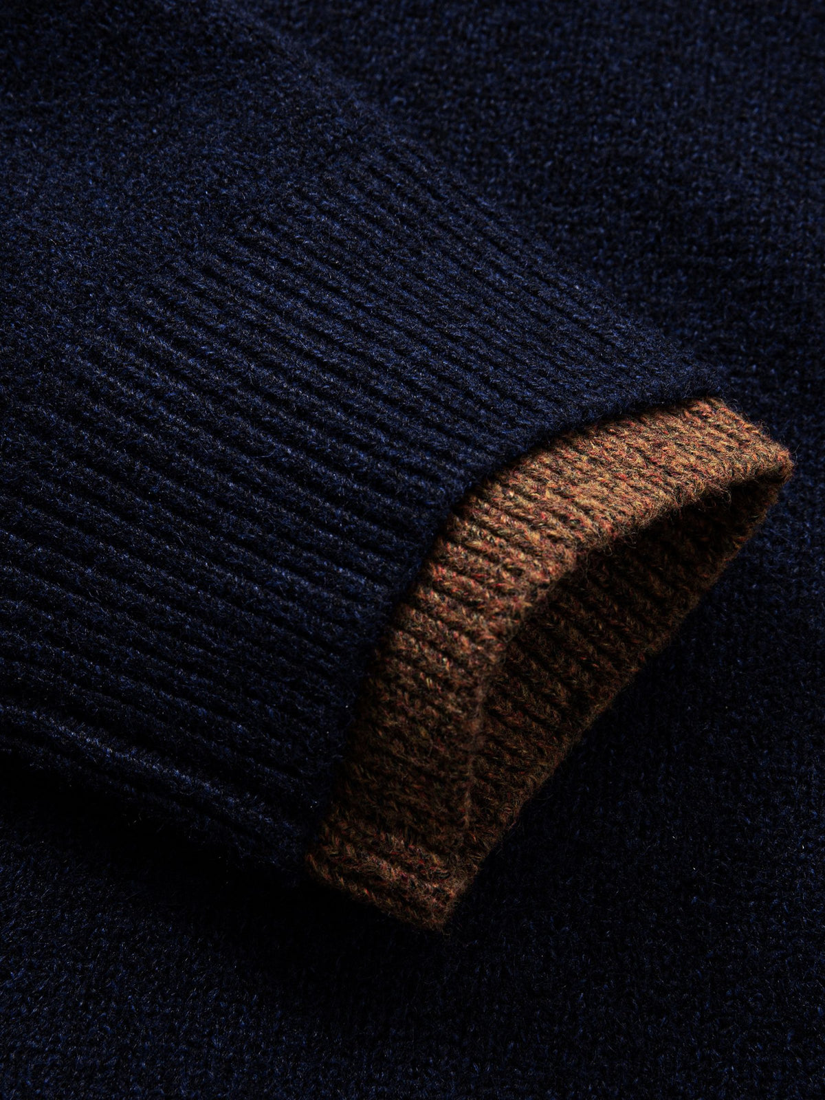 Detailed view of ribbed long sleeve cuffs with subtle contrast tipping