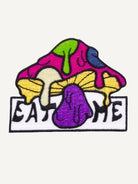 Embroidered Eat Me wild mushroom artwork detail on OROMEN T-shirt