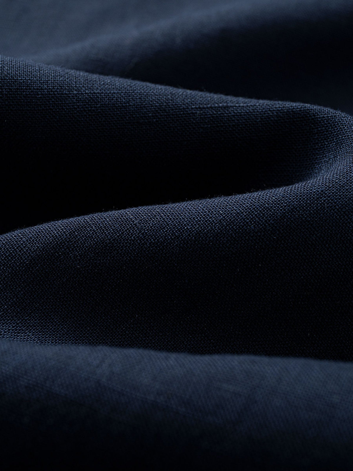 Fabric texture close-up of OROMEN linen-cotton blend trousers in Navy