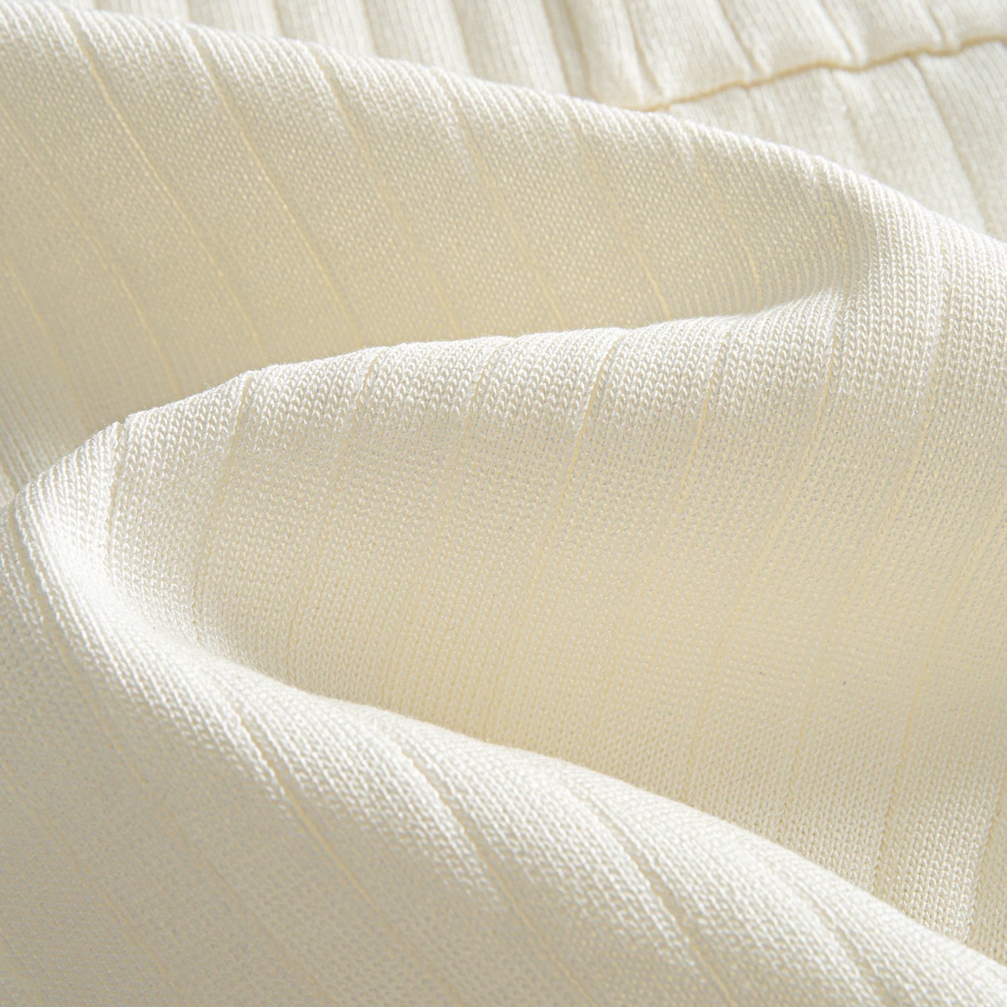 Fine vertical ribbed knit fabric texture detail on cream polo shirt,
100% polyester, lightweight and shape-retaining construction – OROMEN
