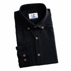 Folded men's black linen-cotton woven shirt, flat lay on white background – OROMEN