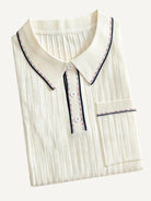 Folded view of OROMEN Cream Court Knit Polo