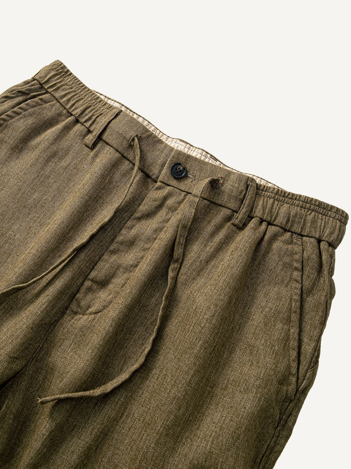 Front waistband detail of OROMEN Herringbone Weave Linen Trousers with drawcord
