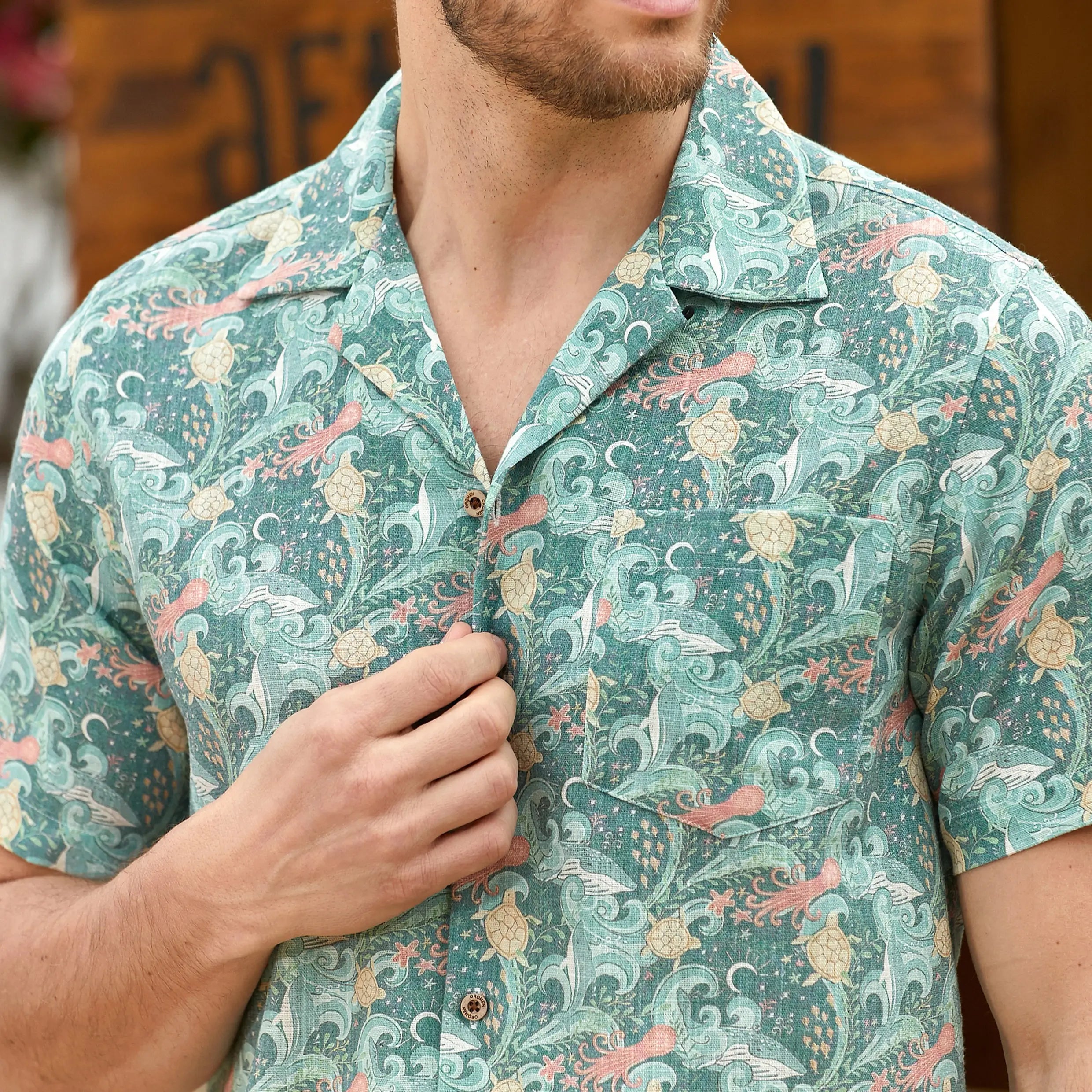 Hand-painted coral reef and ocean flora detail on Undersea Oasis shirt