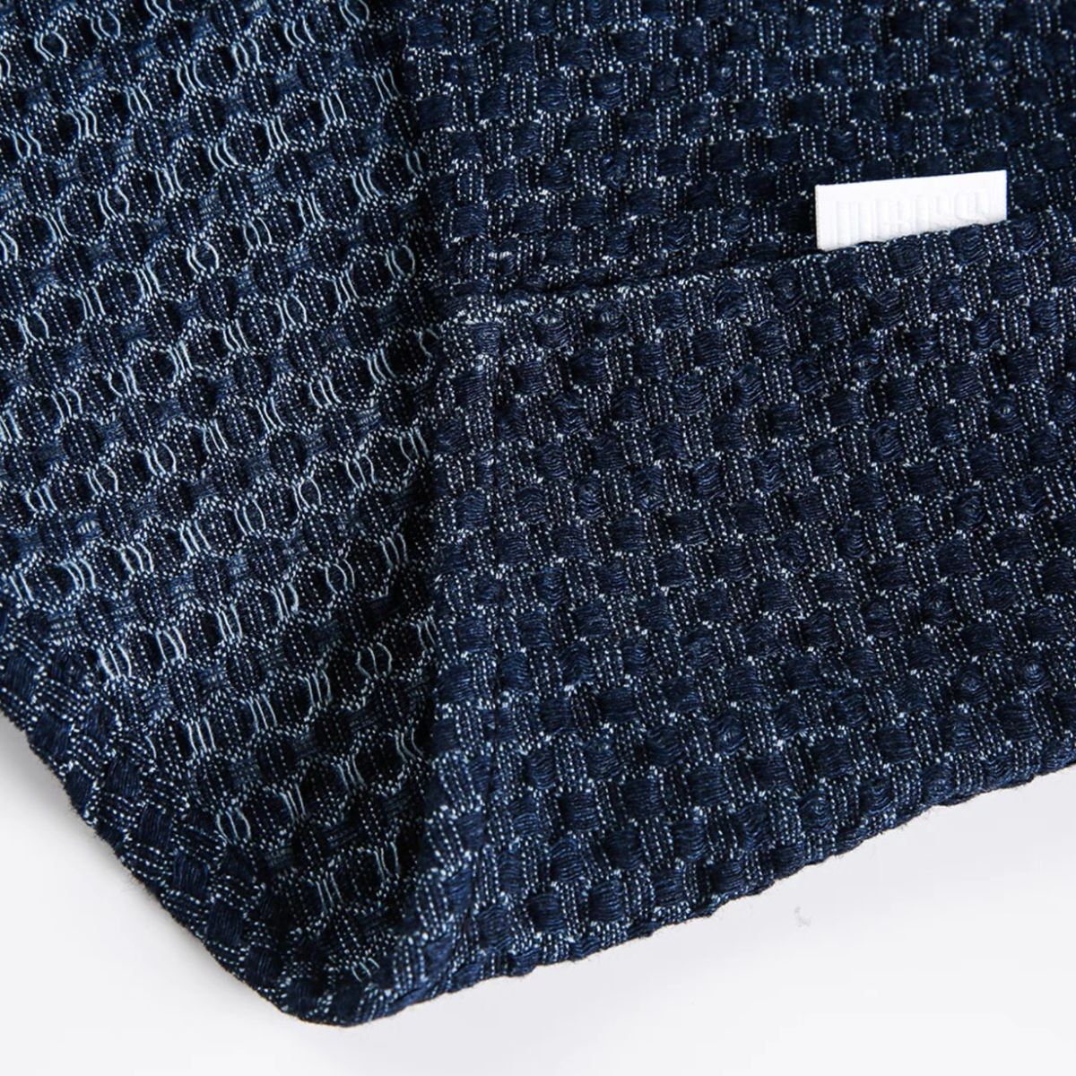 Hem detail of OROMEN OROAW042 Checkered Jacquard Shirt, clean finished shirt hem, navy blue checkered jacquard, straight cut