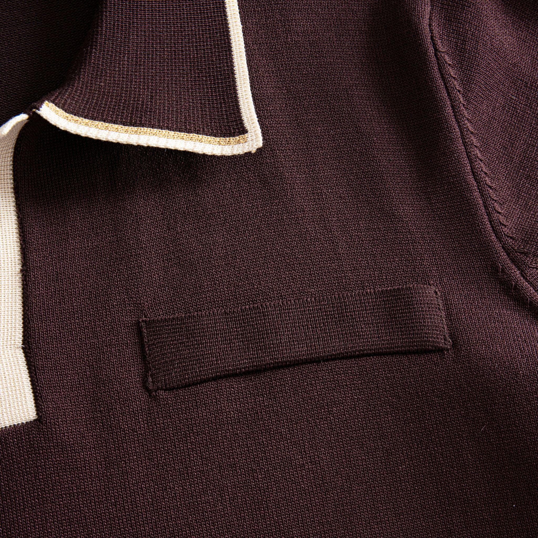 Left chest welt pocket close-up on OROMEN chocolate brown viscose
knit polo, refined pocket detail on smooth knit body
