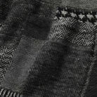 Macro detail of OROMEN KIMONO021 houndstooth fabric, grey woven pattern, patchwork textile surface, Japanese artisan craftsmanship