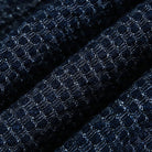 Macro detail of OROMEN OROAW042 jacquard fabric, navy blue checkered woven pattern, raised texture surface, 100% cotton craftsmanship