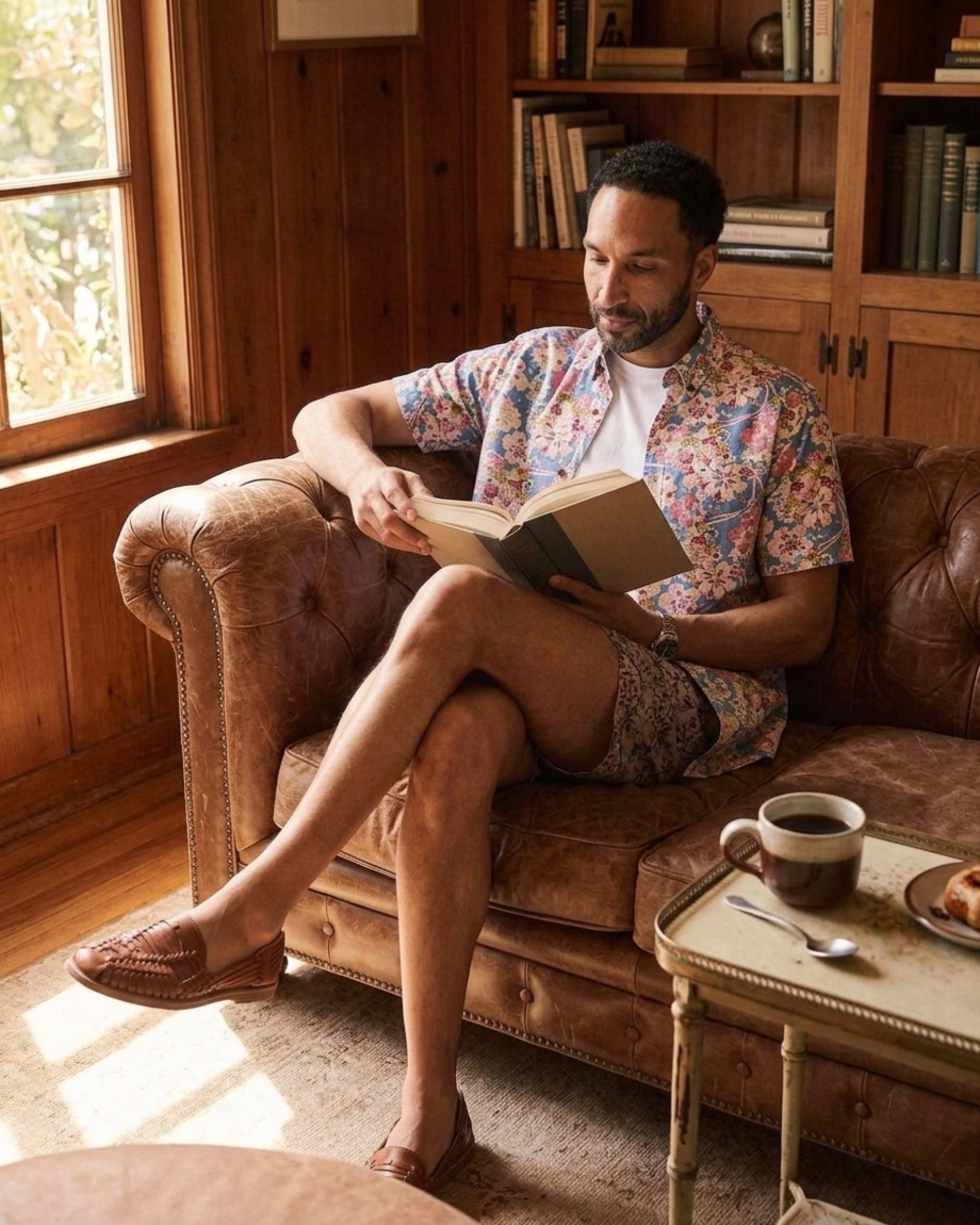 Man in a Japanese-inspired floral print shirt relaxing in a reading