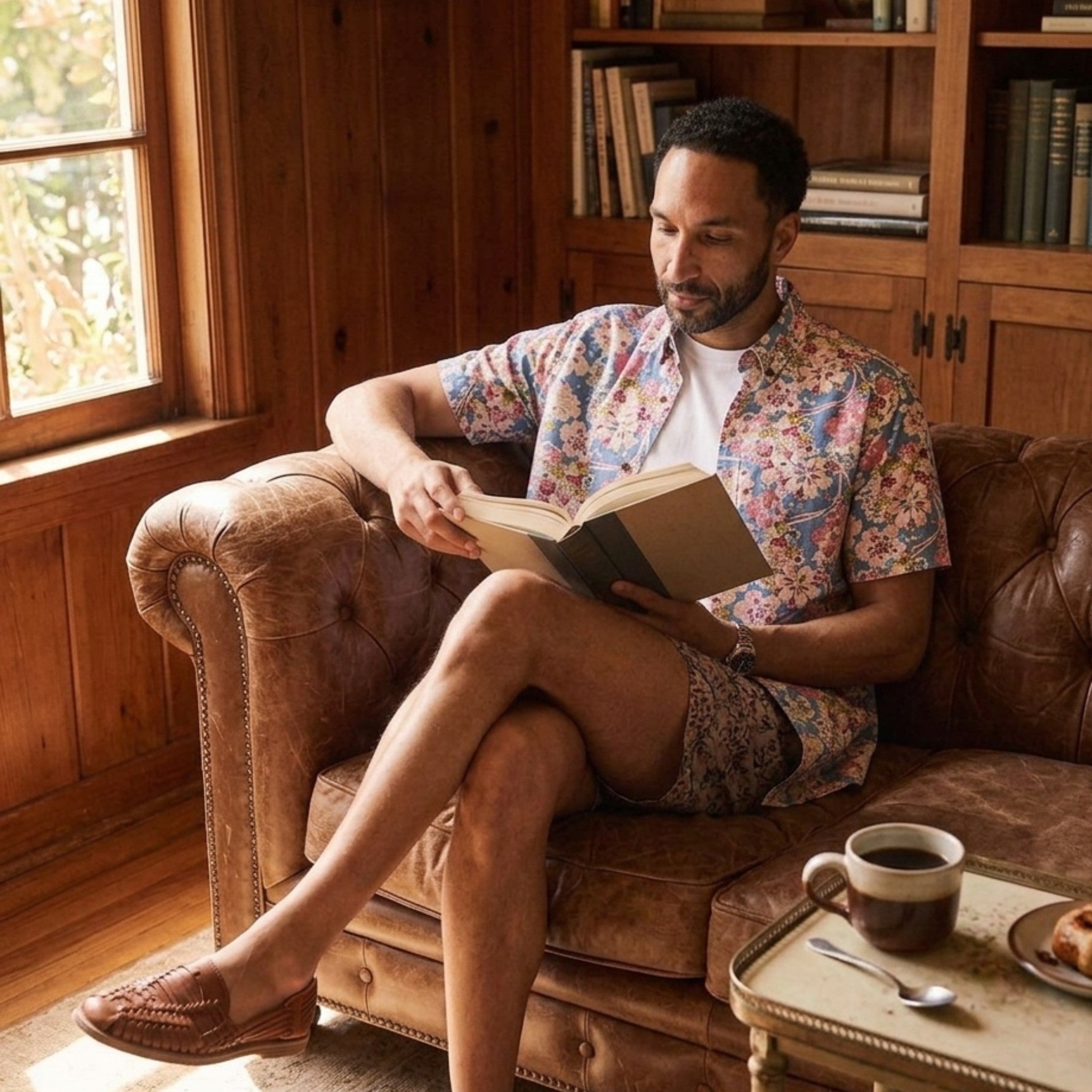 Man in a Japanese-inspired floral print shirt relaxing in a study