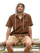 Model seated wearing OROMEN Rust Hooded Utility Shirt