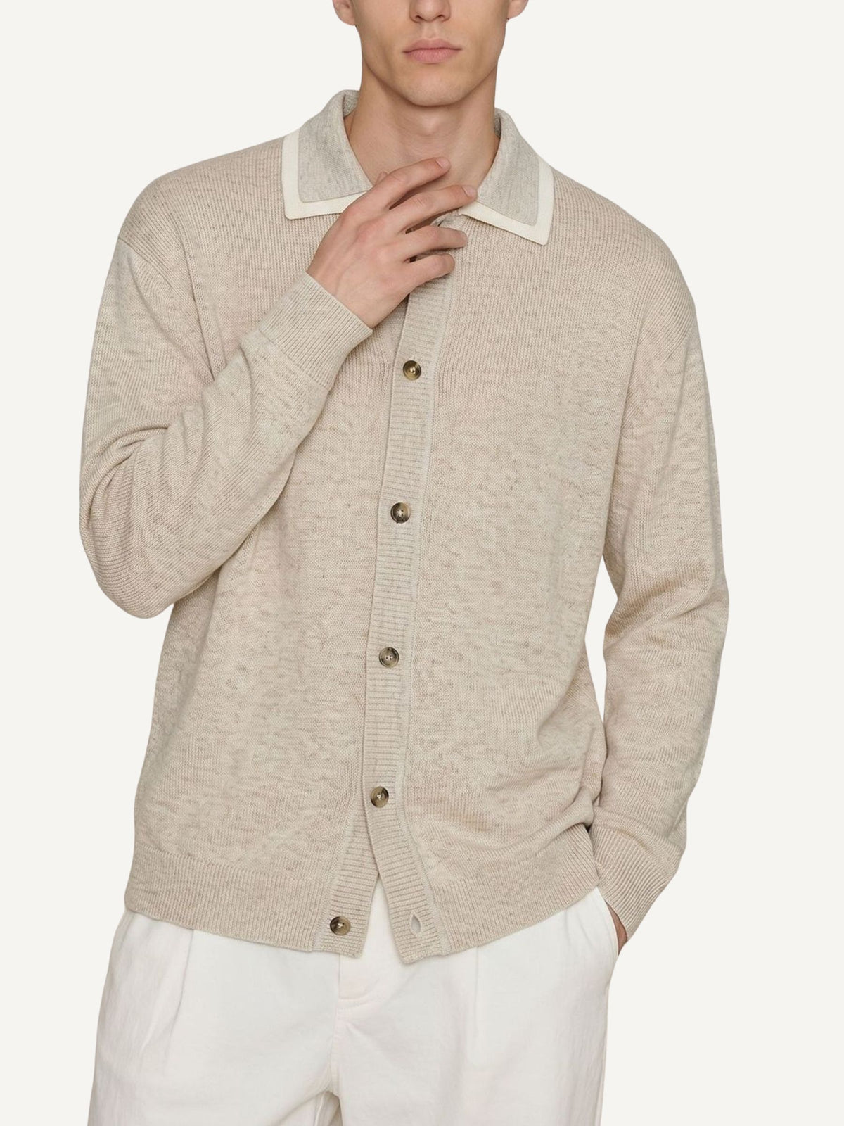 Model wearing OROMEN Contrast Polo Collar Sweater Cardigan in oatmeal paired with trousers