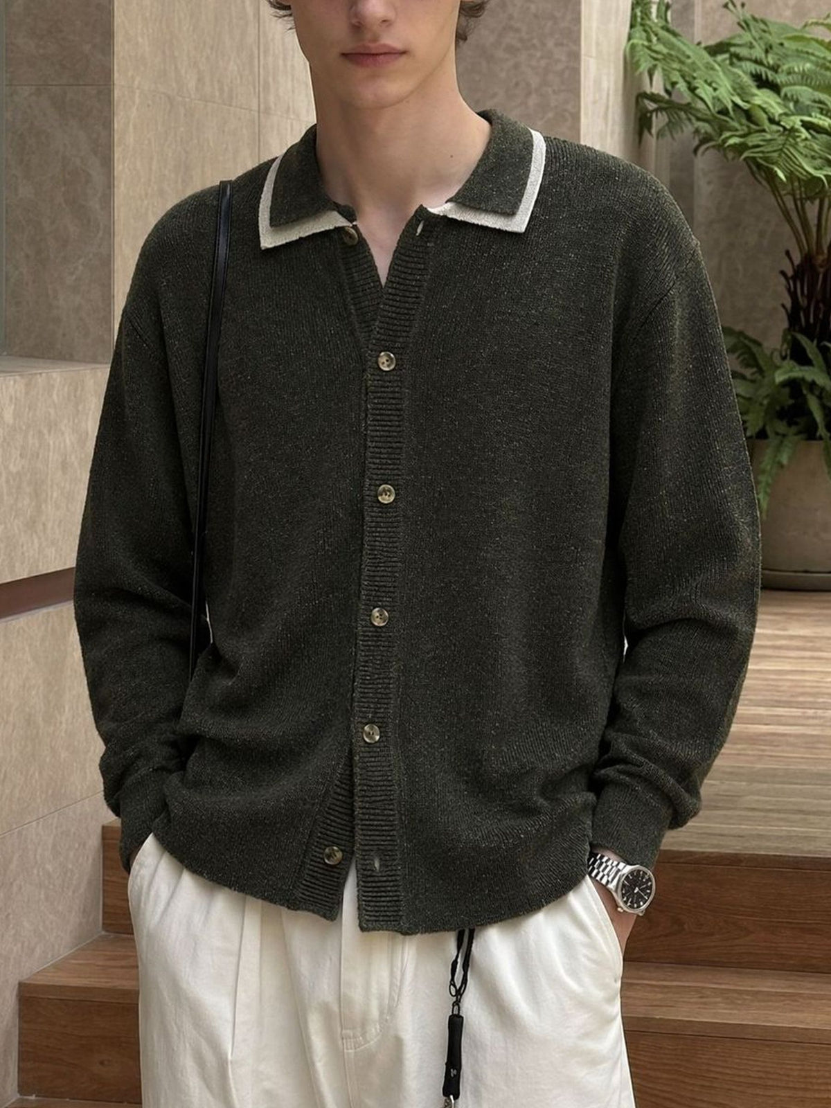 Model wearing OROMEN Contrast Trim Polo Collar Knit Cardigan in olive green paired with trousers