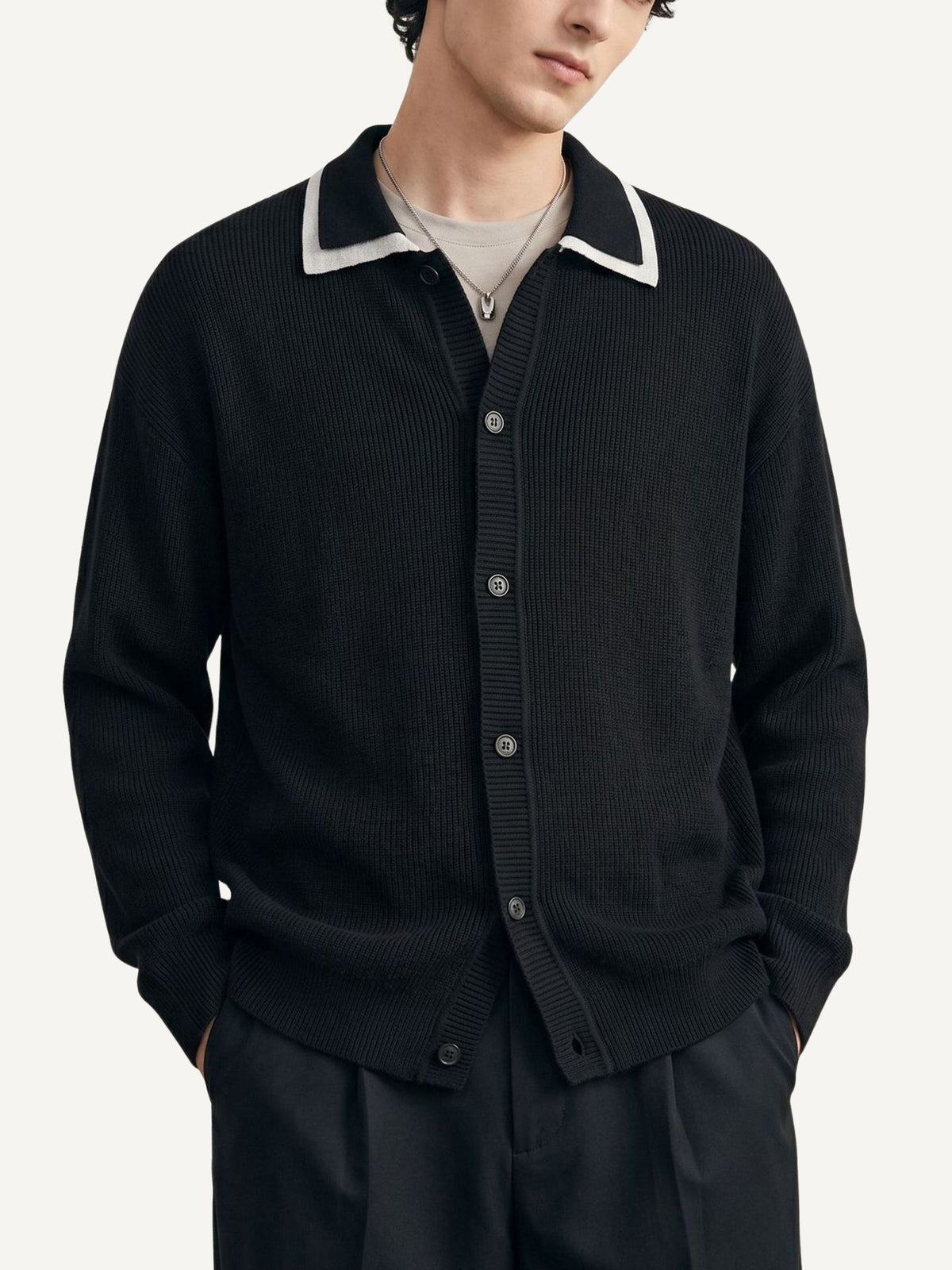 Model wearing OROMEN Monochrome Contrast Trim Polo Knit Cardigan in black paired with trousers