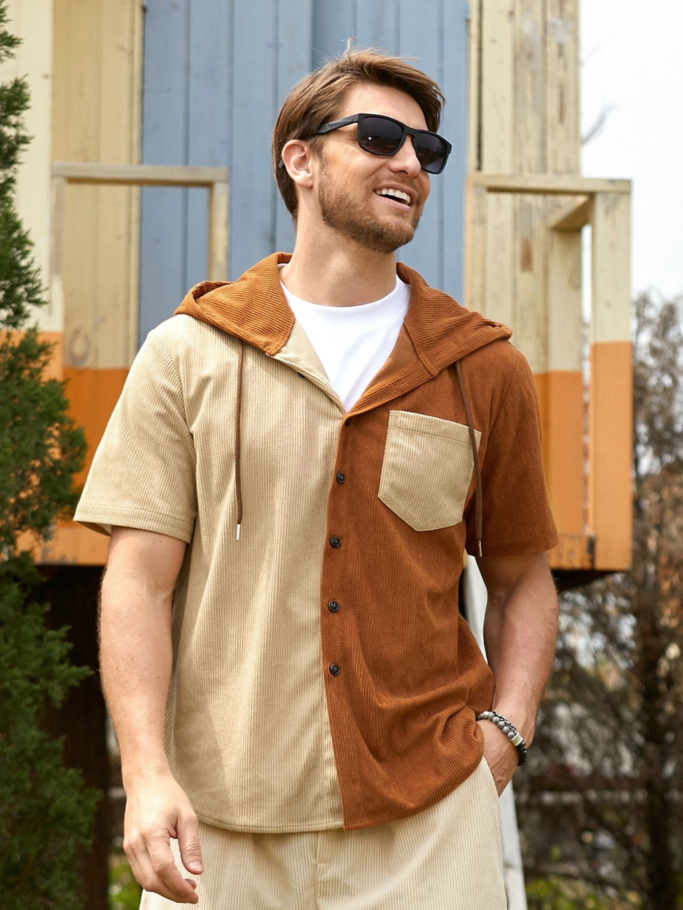 Model wearing OROMEN rust and beige corduroy colorblock hooded shirt, front view