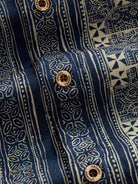 Natural coconut button closure and front placket detail of OROMEN Indigo Batik Shirt