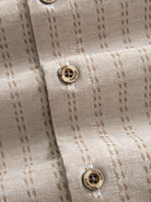 Natural coconut button closure and front placket detail of OROMEN Sashiko Stripe Cotton Shirt