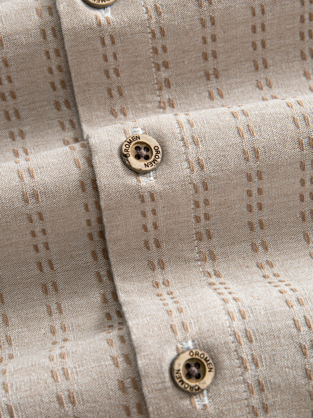 Natural coconut button closure and front placket detail of OROMEN Sashiko Stripe Cotton Shirt
