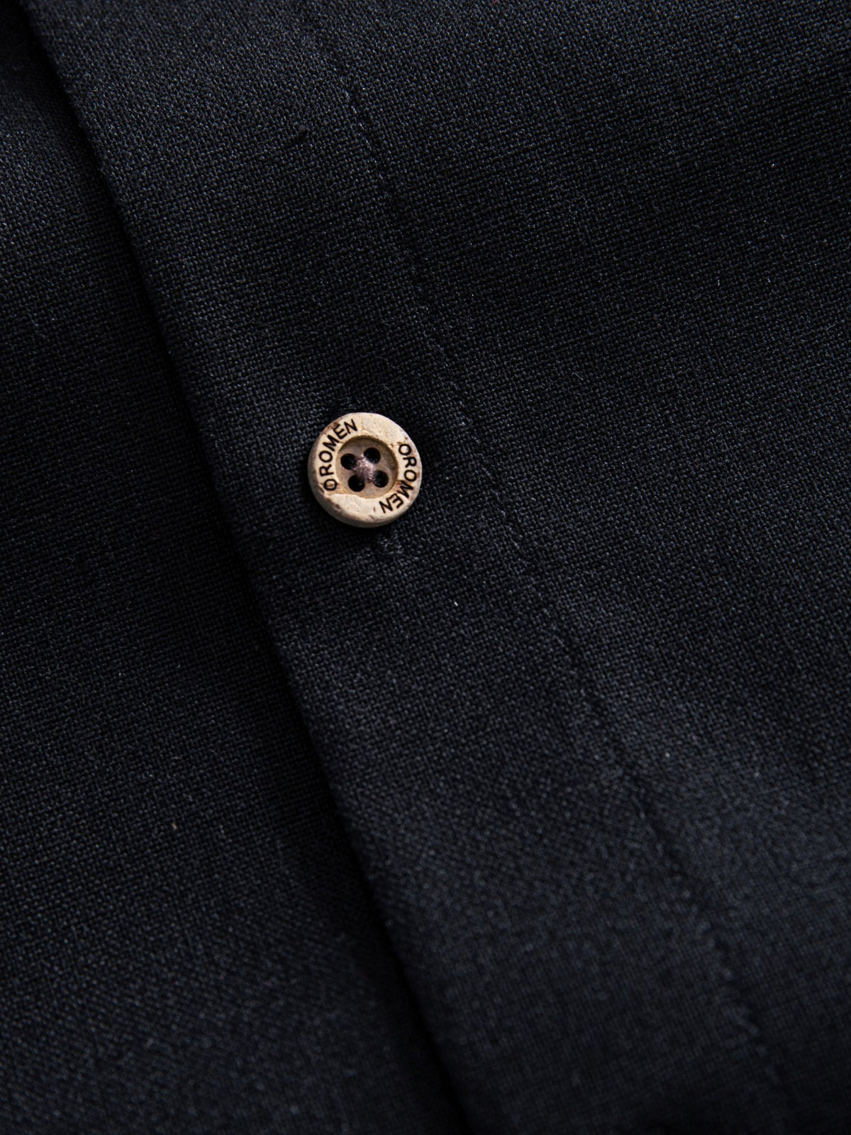 Natural coconut button closure detail of OROMEN Ink Wash Cotton-Linen Shirt