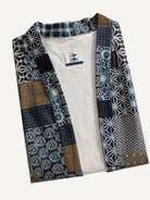 Neatly folded Indigo Asanoha Patchwork Haori Jacket showcasing cotton twill texture and multi-pattern print
