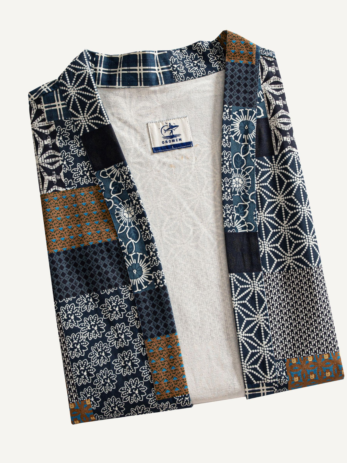 Neatly folded Indigo Asanoha Patchwork Haori Jacket showcasing cotton twill texture and multi-pattern print