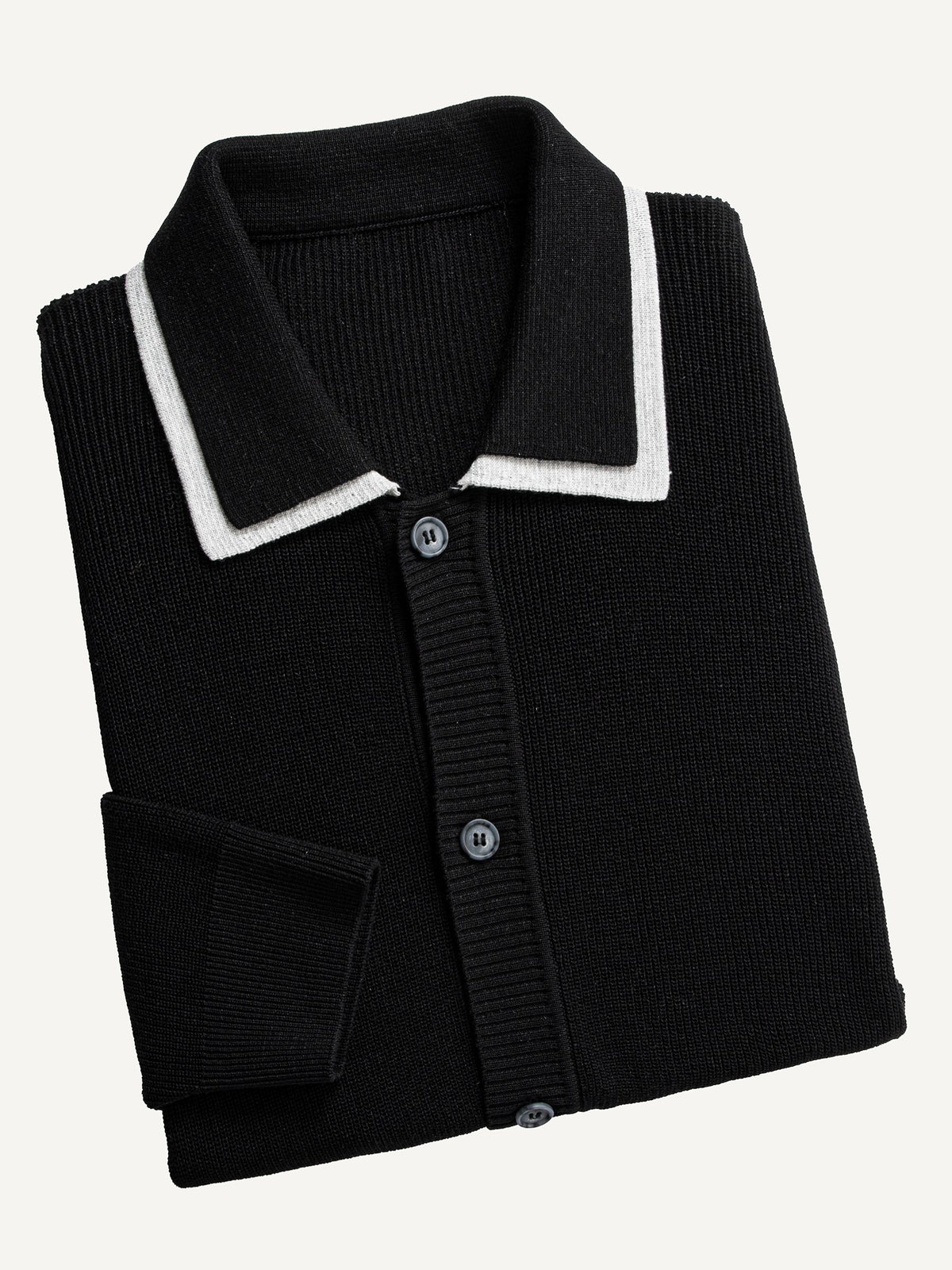 Neatly folded OROMEN Monochrome Contrast Trim Polo Knit Cardigan highlighting white collar trim and ribbed texture